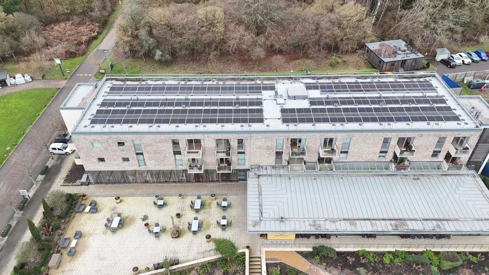 Drone view of a Djuka commercial solar install on a large flat-roof building